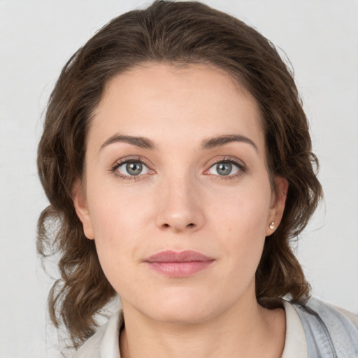 Joyful white young-adult female with medium  brown hair and green eyes