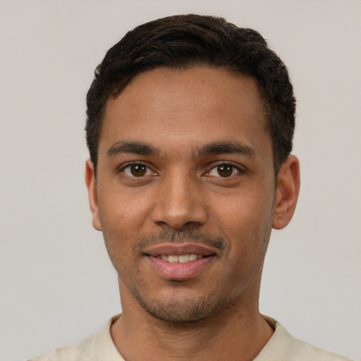 Joyful latino young-adult male with short  black hair and brown eyes