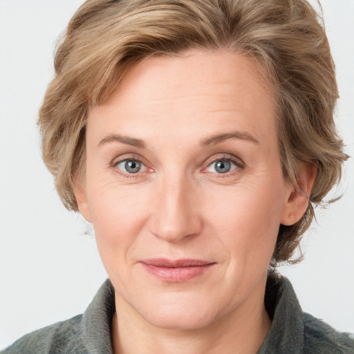 Joyful white adult female with medium  brown hair and blue eyes