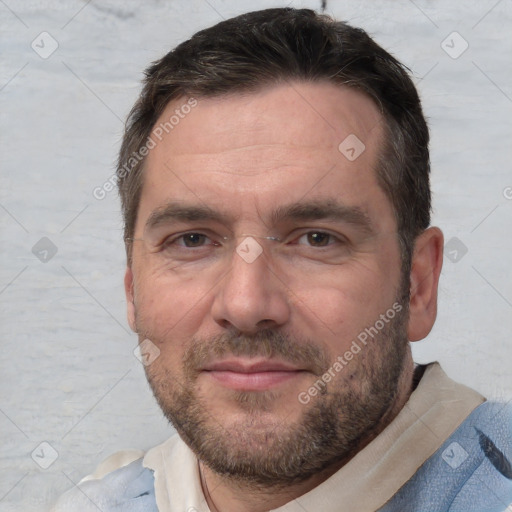 Joyful white adult male with short  brown hair and brown eyes