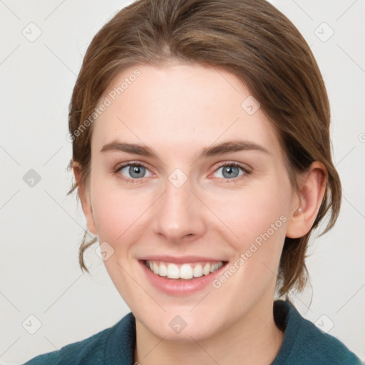 Joyful white young-adult female with medium  brown hair and blue eyes