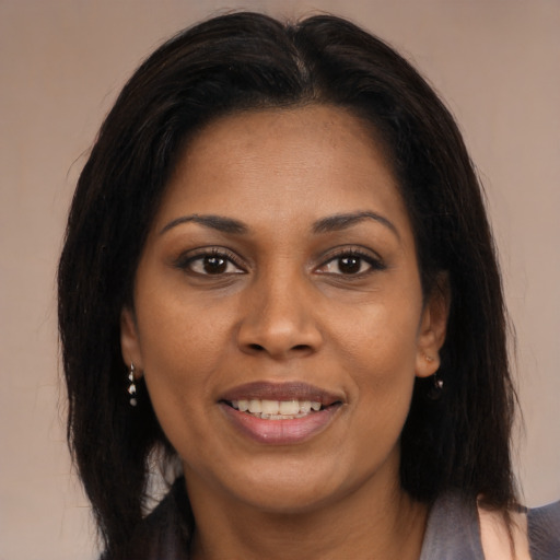 Joyful black young-adult female with medium  brown hair and brown eyes