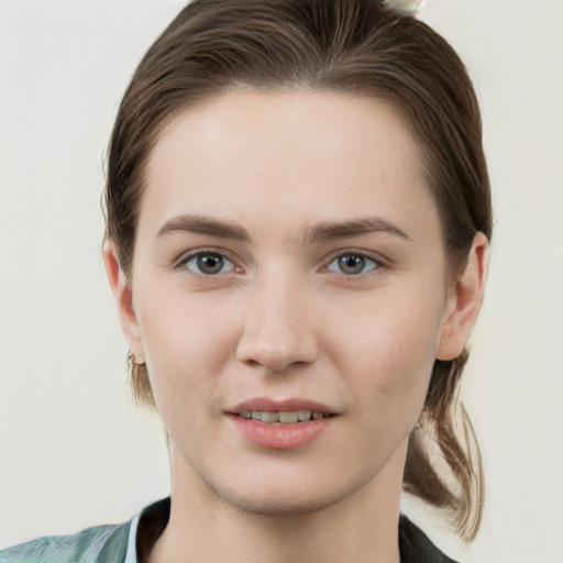 Joyful white young-adult female with medium  brown hair and grey eyes