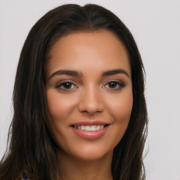 Joyful latino young-adult female with long  brown hair and brown eyes