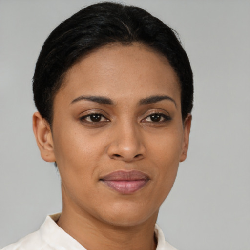 Joyful latino young-adult female with short  brown hair and brown eyes