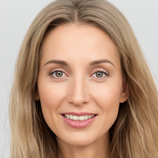 Joyful white young-adult female with long  brown hair and grey eyes