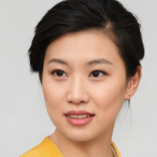 Joyful asian young-adult female with short  brown hair and brown eyes