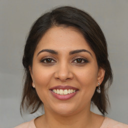 Joyful latino young-adult female with medium  brown hair and brown eyes