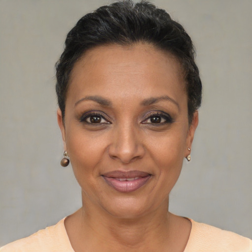 Joyful black adult female with short  brown hair and brown eyes
