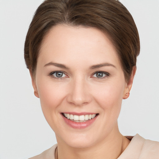 Joyful white young-adult female with short  brown hair and brown eyes