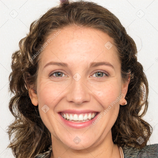 Joyful white adult female with medium  brown hair and green eyes