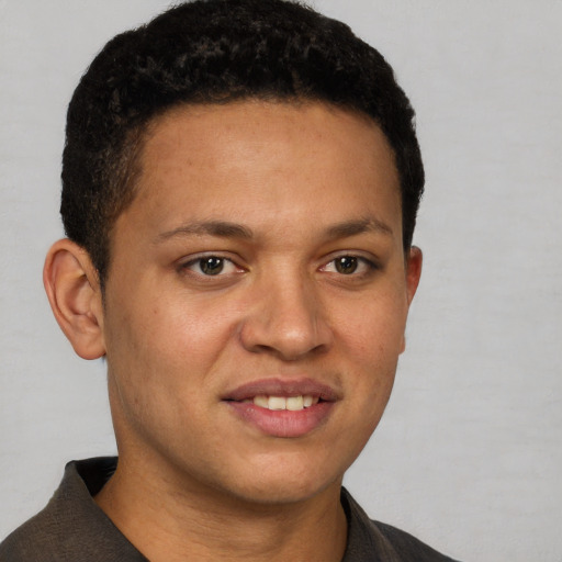 Joyful latino young-adult male with short  brown hair and brown eyes