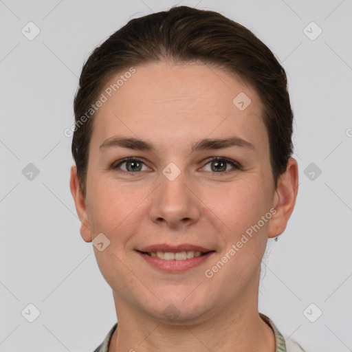 Joyful white young-adult female with short  brown hair and grey eyes