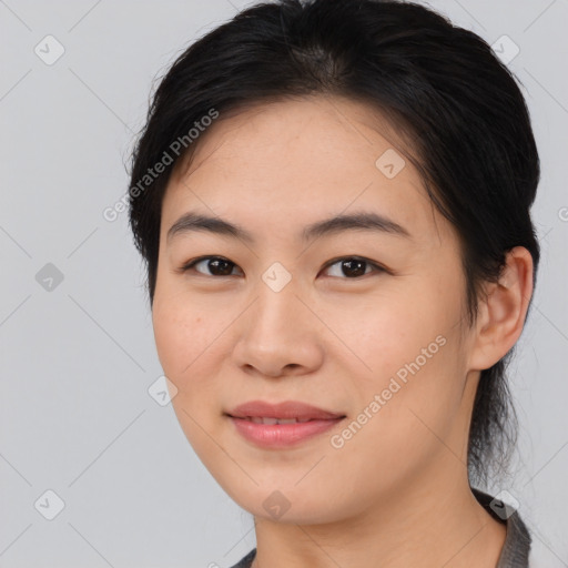 Joyful asian young-adult female with medium  black hair and brown eyes