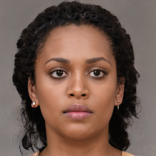 Neutral black young-adult female with long  brown hair and brown eyes