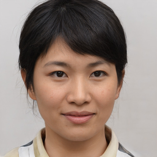 Joyful asian young-adult female with medium  brown hair and brown eyes