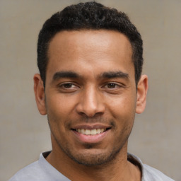 Joyful latino young-adult male with short  black hair and brown eyes