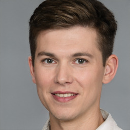 Joyful white young-adult male with short  brown hair and grey eyes