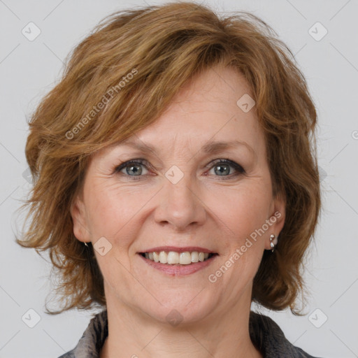 Joyful white adult female with medium  brown hair and grey eyes