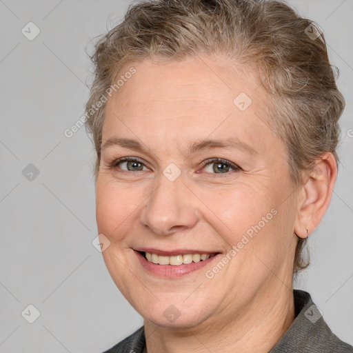 Joyful white adult female with medium  brown hair and grey eyes