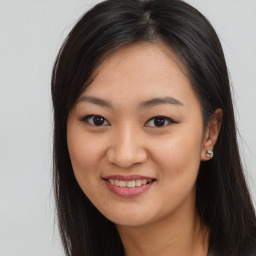 Joyful asian young-adult female with long  brown hair and brown eyes