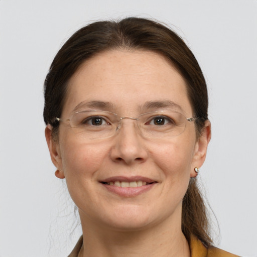 Joyful white adult female with short  brown hair and grey eyes