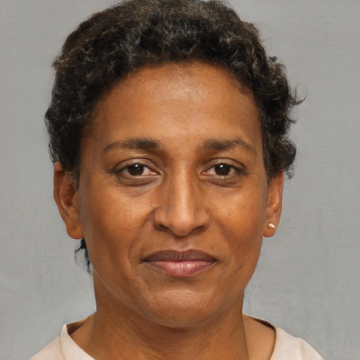 Joyful black adult female with short  brown hair and brown eyes