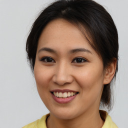 Joyful asian young-adult female with medium  brown hair and brown eyes