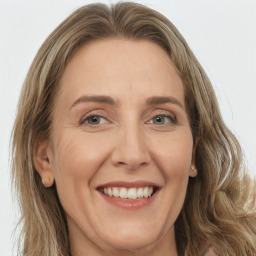Joyful white adult female with long  brown hair and green eyes