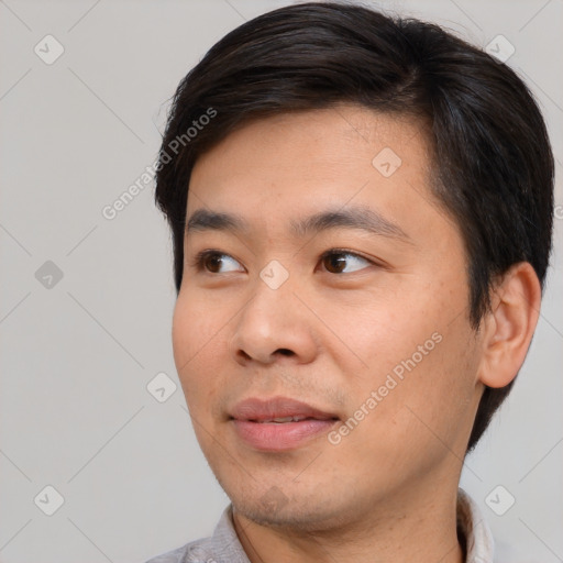 Joyful asian young-adult male with short  brown hair and brown eyes