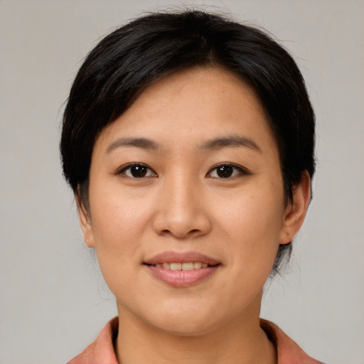 Joyful asian young-adult female with medium  brown hair and brown eyes
