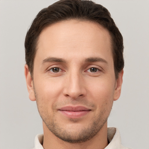 Joyful white young-adult male with short  brown hair and brown eyes