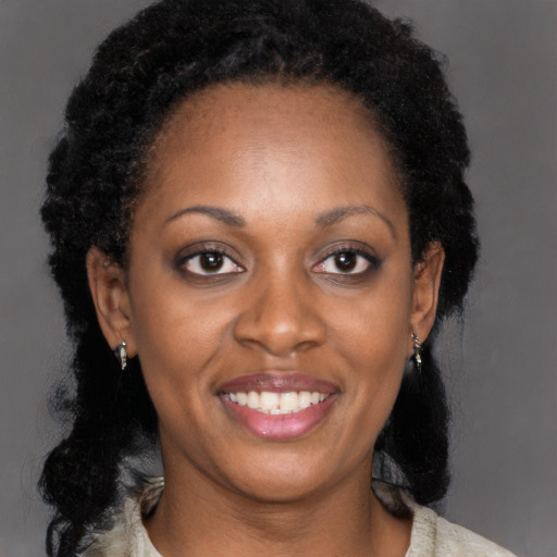 Joyful black adult female with medium  black hair and brown eyes