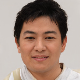 Joyful asian young-adult male with short  brown hair and brown eyes