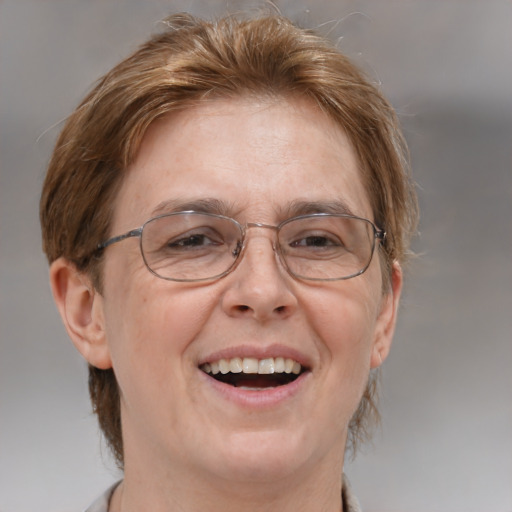 Joyful white middle-aged female with medium  brown hair and blue eyes