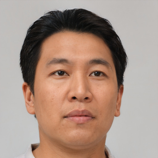Neutral asian adult male with short  brown hair and brown eyes