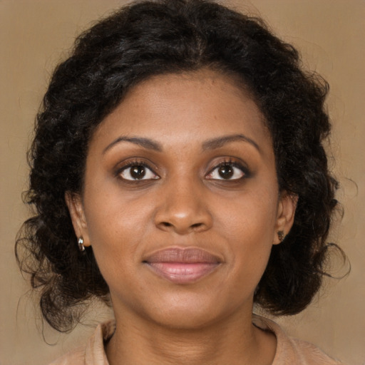 Joyful black young-adult female with medium  brown hair and brown eyes
