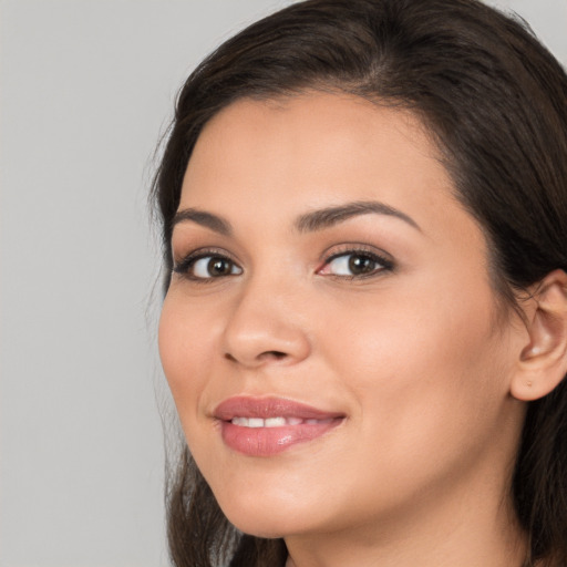 Joyful white young-adult female with long  brown hair and brown eyes