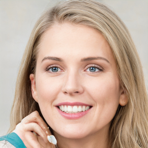 Joyful white young-adult female with long  brown hair and blue eyes