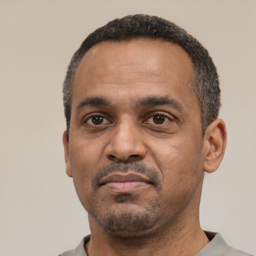 Neutral latino adult male with short  black hair and brown eyes