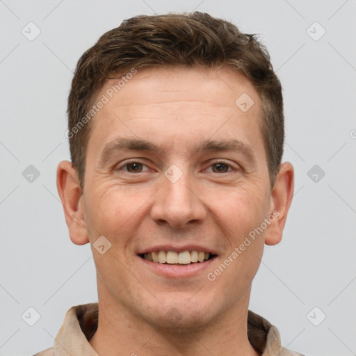 Joyful white adult male with short  brown hair and brown eyes