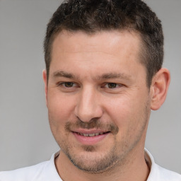 Joyful white adult male with short  brown hair and brown eyes