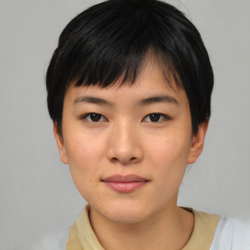 Joyful asian young-adult female with short  black hair and brown eyes
