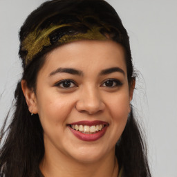 Joyful latino young-adult female with long  brown hair and brown eyes