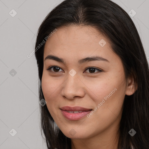 Joyful latino young-adult female with long  brown hair and brown eyes