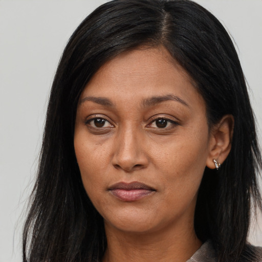 Joyful asian adult female with long  brown hair and brown eyes