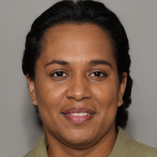 Joyful black adult female with short  brown hair and brown eyes