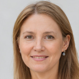 Joyful white adult female with long  brown hair and grey eyes