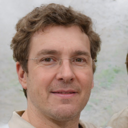 Joyful white adult male with short  brown hair and grey eyes