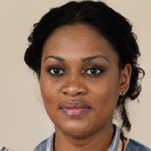 Joyful black adult female with medium  black hair and brown eyes